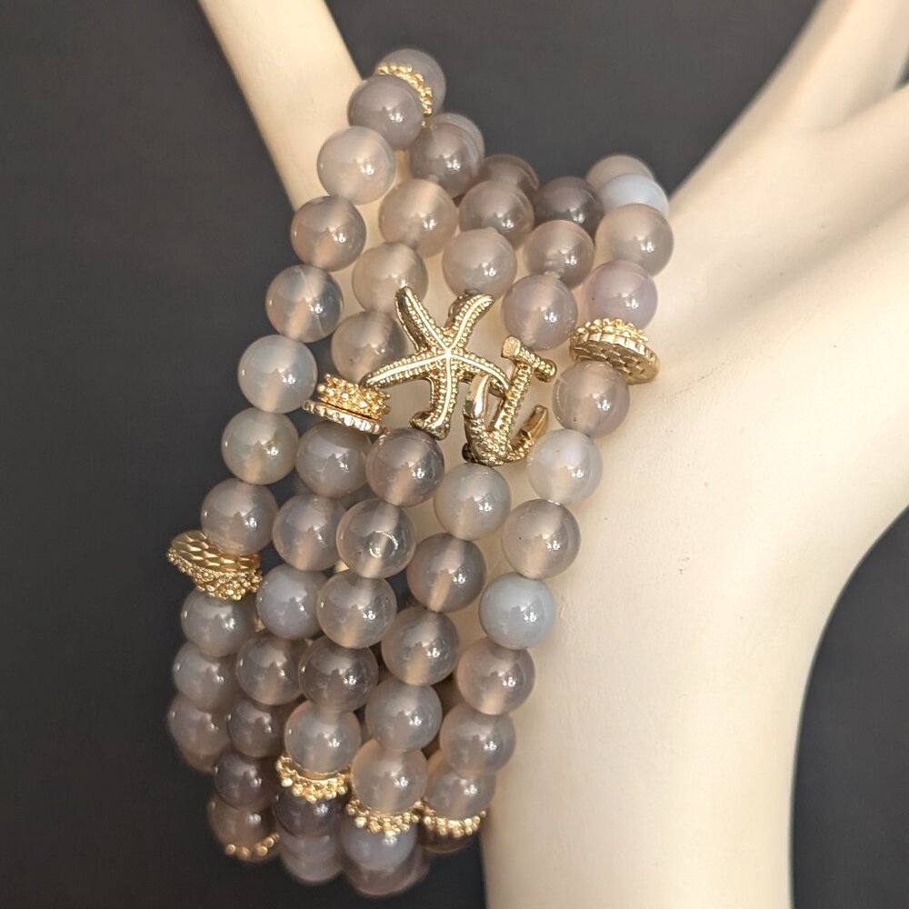 Bundle of gray and grayish blue stretch bracelets with anchor & starfish accents
